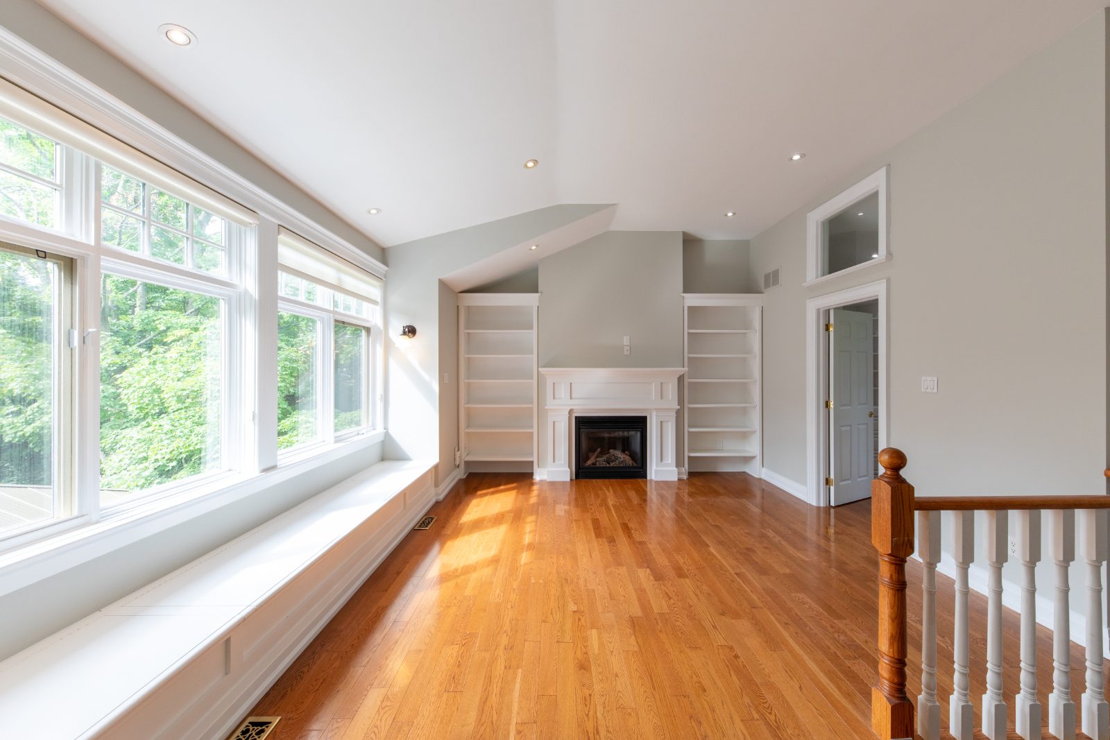 Family lounge with fireplace and built-in bookshelves