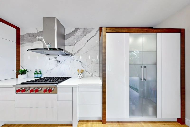 Marble backsplash and walnut-framed cabinetry