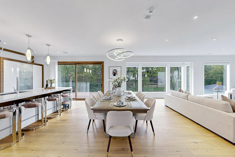 Kitchen, dining and living in one open room, windows to the trees